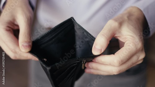 Empty purse in the hands of a man. lack of money. problems with finances, difficulties in life, dysfunction, financial crisis