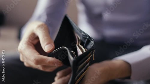 purse with cash in the hands of a man. little money. financial crisis, the economy and inflation. price increases, utility bills bankrupt business