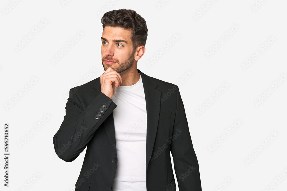 Young business man looking sideways with doubtful and skeptical expression. Young business man looking sideways with doubtful and skeptical expression.