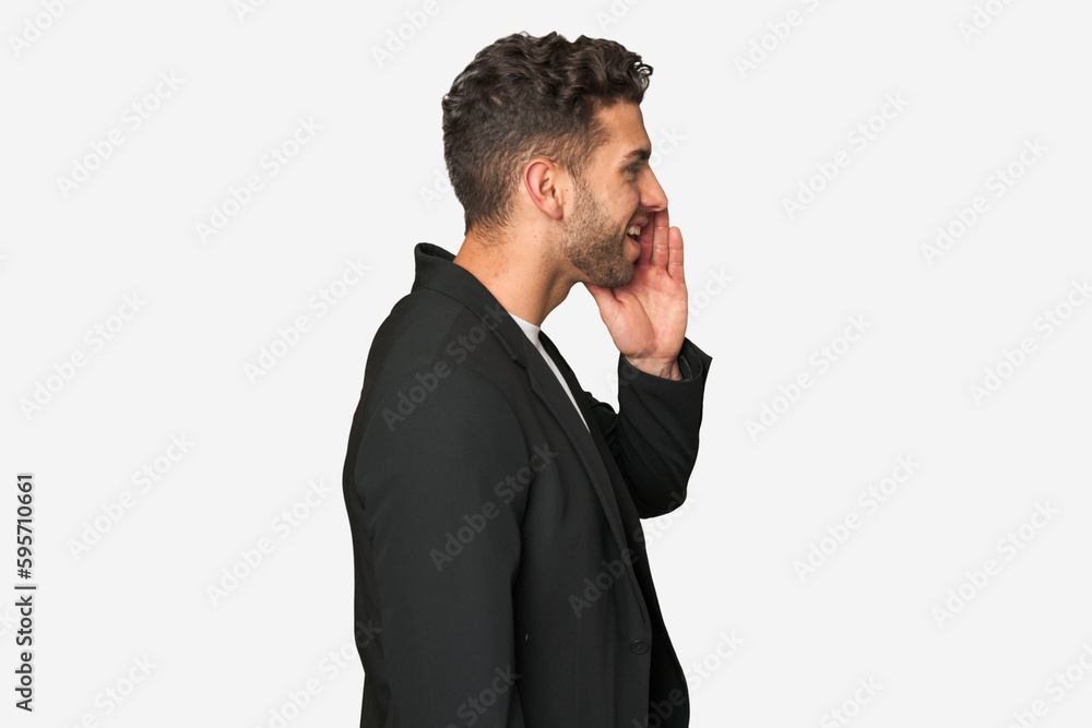 Young business man shouting and holding palm near opened mouth. Young business man shouting and holding palm near opened mouth.