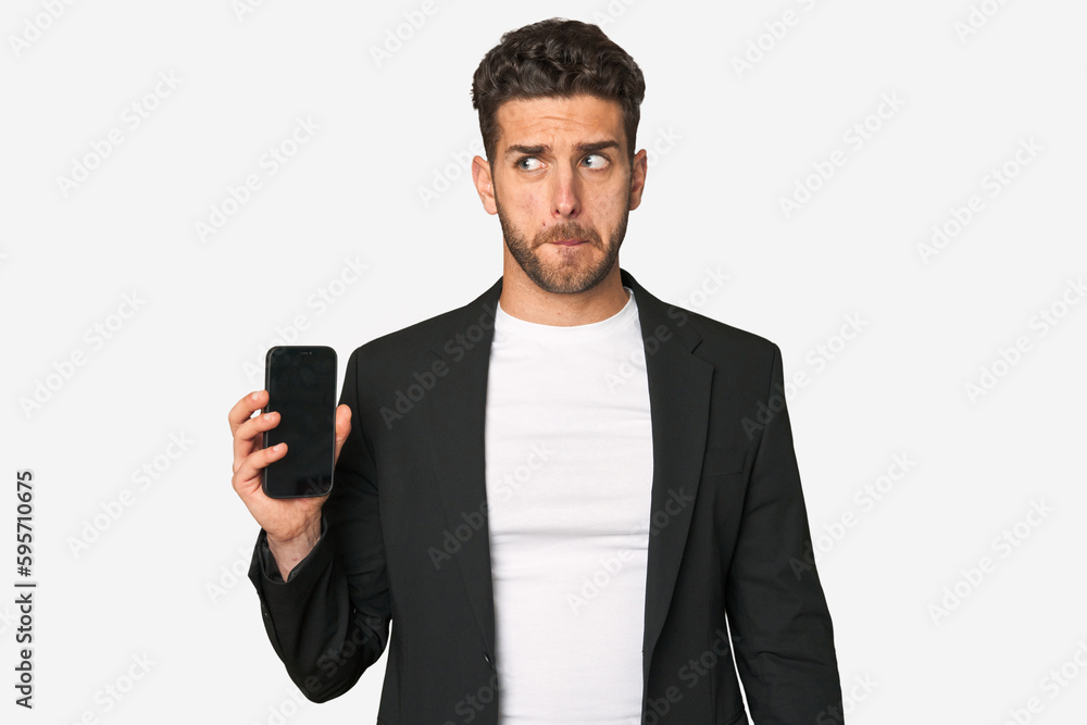 Young business caucasian man confused, feels doubtful and unsure. Young business caucasian man confused, feels doubtful and unsure.