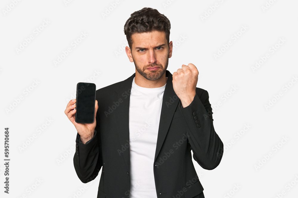 Young business caucasian man showing fist to camera, aggressive facial expression. Young business caucasian man showing fist to camera, aggressive facial expression.