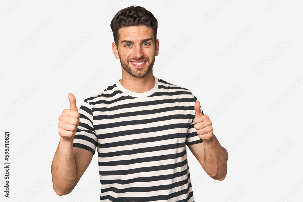 Young handsome man isolated raising both thumbs up, smiling and confident. Young handsome man isolated raising both thumbs up, smiling and confident.