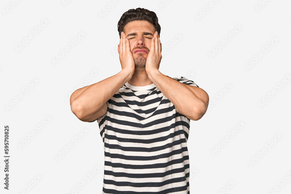 Young handsome man isolated crying, unhappy with something, agony and confusion concept. Young handsome man isolated crying, unhappy with something, agony and confusion concept.