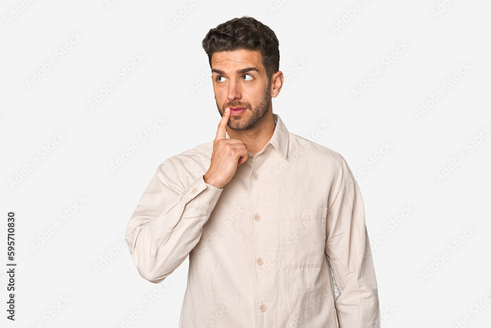 Young handsome man isolated looking sideways with doubtful and skeptical expression. Young handsome man isolated looking sideways with doubtful and skeptical expression.