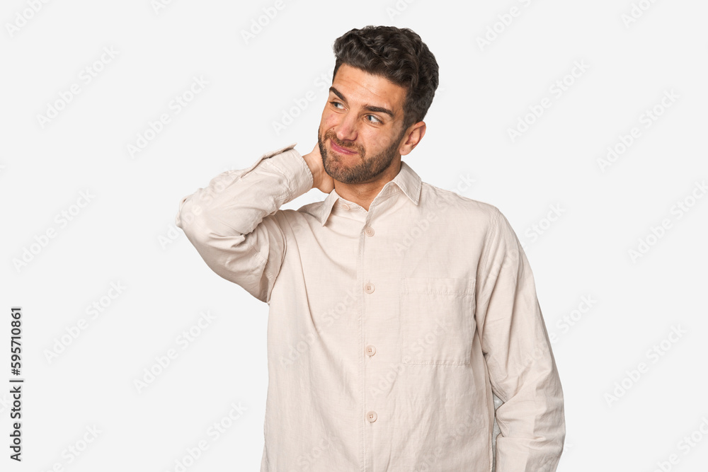 Young handsome man isolated touching back of head, thinking and making a choice. Young handsome man isolated touching back of head, thinking and making a choice.