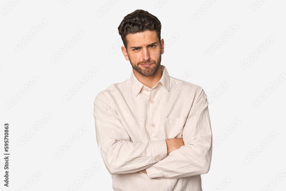 Young handsome man isolated frowning face in displeasure, keeps arms folded. Young handsome man isolated frowning face in displeasure, keeps arms folded.