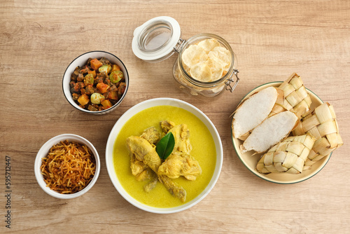 Opor Ayam, served with ketupat, sambal goreng ati, keripik kentang and emping. Popular during Eid al Fitr. Indonesian traditional food 