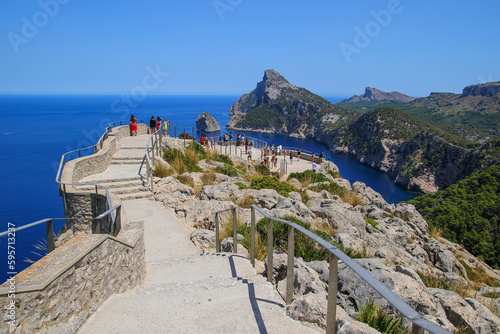Tourists enjoying a breathtaking view over Cape Formentor at the mirador (