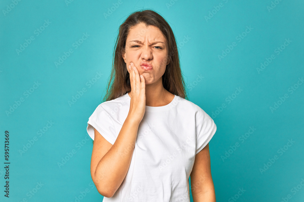 A young caucasian woman isolated having a strong teeth pain, molar ache. A young caucasian woman isolated having a strong teeth pain, molar ache.
