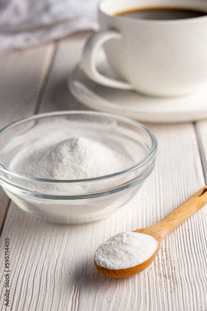 Herbal sweetener stevia in spoon and a cup of coffee Herbal sweetener stevia in spoon and a cup of coffee
