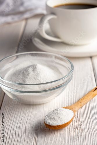 Herbal sweetener stevia in spoon and a cup of coffee