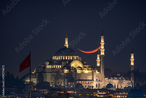 Crescent moon sunset with Suleymaniye Mosque (Ottoman imperial mosque). View from Üsküdar in Istanbul. Turkish Century 2023