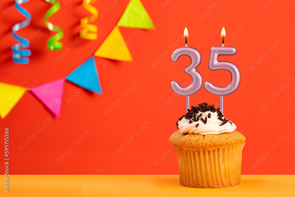Birthday cake with number 35 candle - Sparkling orange background with bunting
