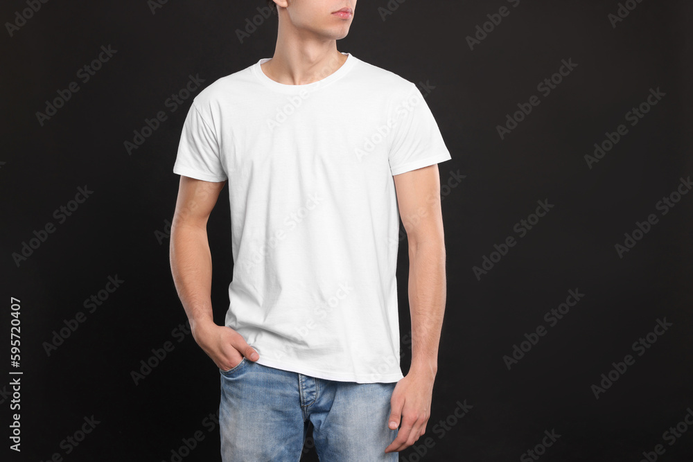 Man wearing white t-shirt on black background, closeup. Mockup for design Man wearing white t-shirt on black background, closeup. Mockup for design
