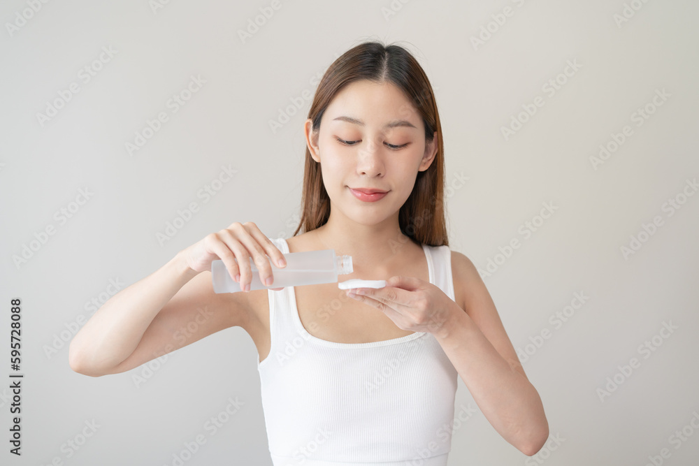 Close-up view hands of woman using toner and cotton pad to remove makeup Close-up view hands of woman using toner and cotton pad to remove makeup