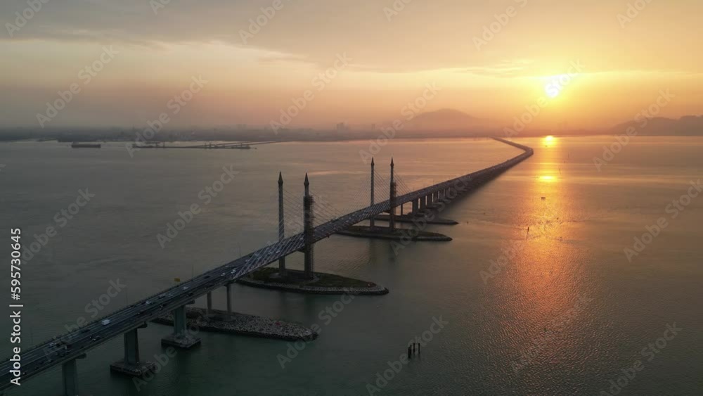 Aerial view golden sun over silhouette Penang Bridge cross sea Aerial view golden sun over silhouette Penang Bridge cross sea