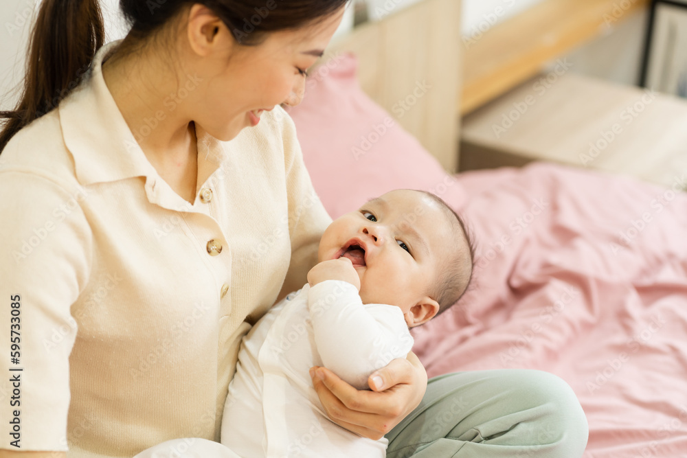 Asian mother and newborn baby feet are smiling and happy Asian mother and newborn baby feet are smiling and happy