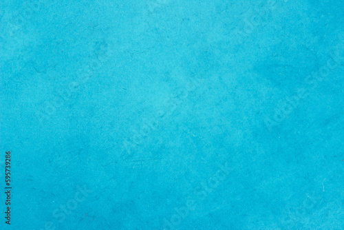 Blue light concrete texture for background in summer wallpaper. Cyan cement colour sand wall of tone vintage. Abstract teal dark color.  © Manitchaya