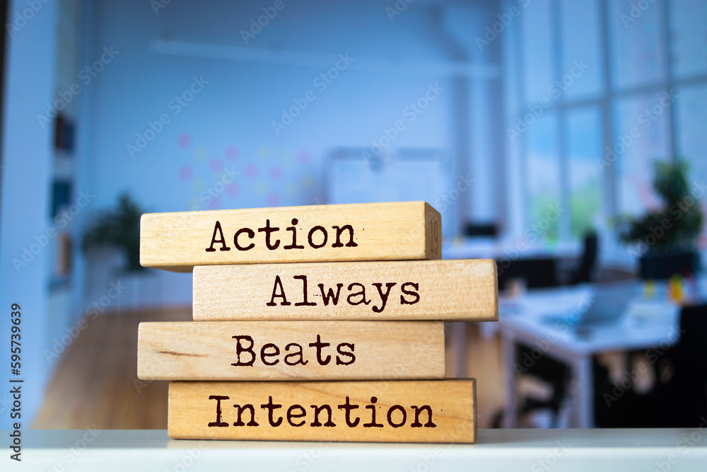 Wooden blocks with words 'Action Always Beats Intention'. Wooden blocks with words 'Action Always Beats Intention'.