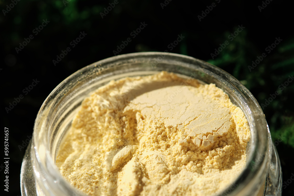 An open jar of a yellow turmeric facial scrub showing off its texture. An open jar of a yellow turmeric facial scrub showing off its texture.