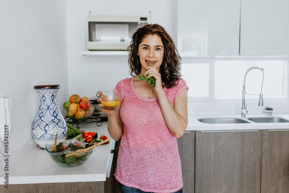 Latin woman healthy eating in the kitchen at home in Mexico, Hispanic people wellbeing Latin woman healthy eating in the kitchen at home in Mexico, Hispanic people wellbeing