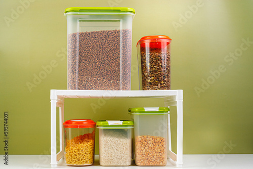 Kitchen shelf with bulk products. Containers for storing rice, cereals. organization of food storage in the kitchen, transparent reusable jars for cereals and pasta, zero waste pantry