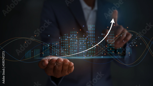 Businessmen touching the virtual screen with the stock market changes, business growth investment bar chart, and more candlesticks connected to trade data, businessmen pointing the arrow.