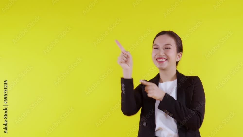 Portrait young asian business woman pointing and presenting isolated on yellow background, advertising and marketing, executive and manager, businesswoman confident showing something with expression. Portrait young asian business woman pointing and presenting isolated on yellow background, advertising and marketing, executive and manager, businesswoman confident showing something with expression.