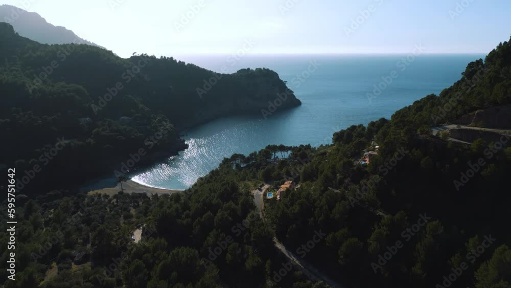 Pristine Palma de Mallorca Island, Cala Tuent near Sa Calobra. Natural idyllic turquoise blue clear sea water, sandy beach seaside cliff coast. Spanish Balearic Majorca, cinematic aerial drone 4K UHD