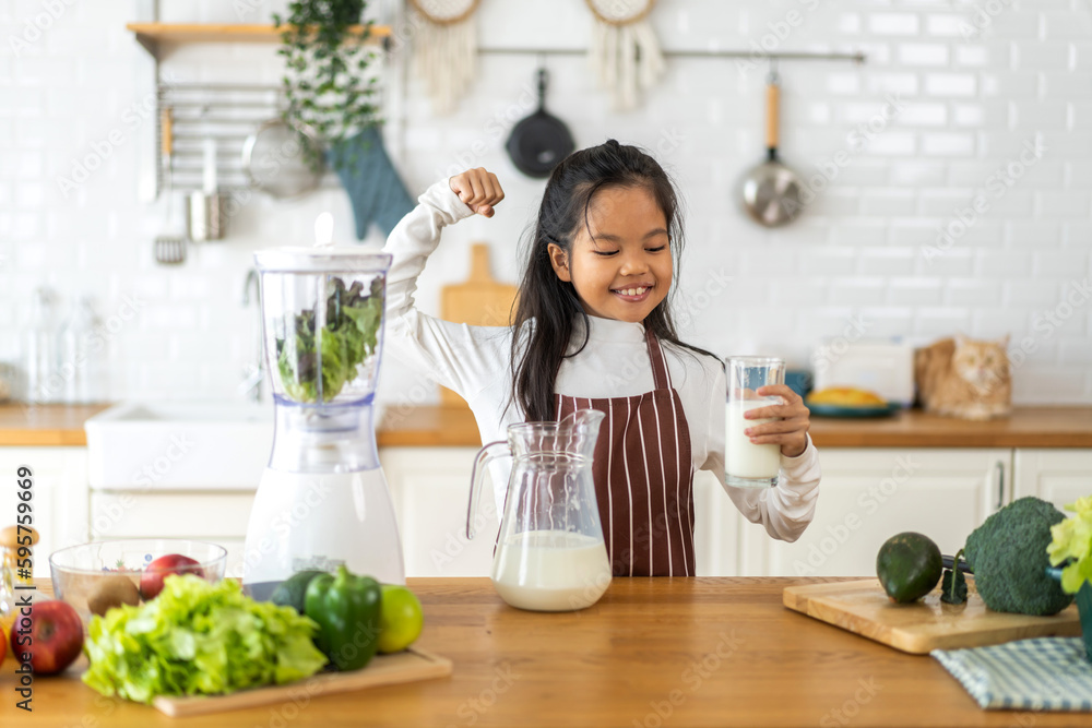 Portrait of enjoy happy little asian child girl smiling having protein breakfast drinking and hold glasses of fresh milk,healthy nutrition,calcium and vitamin,dairy product,strong and growth 