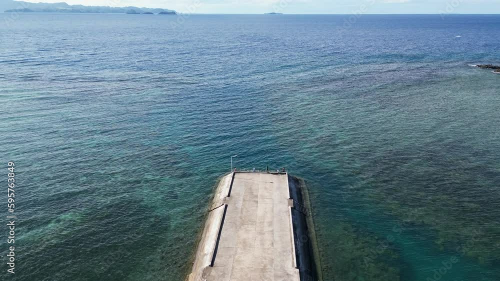 Bird's eye View of Cemented Dock facing breathtaking, clear ocean waters and coral reefs in Catanduanes, Philippines. Bird's eye View of Cemented Dock facing breathtaking, clear ocean waters and coral reefs in Catanduanes, Philippines.