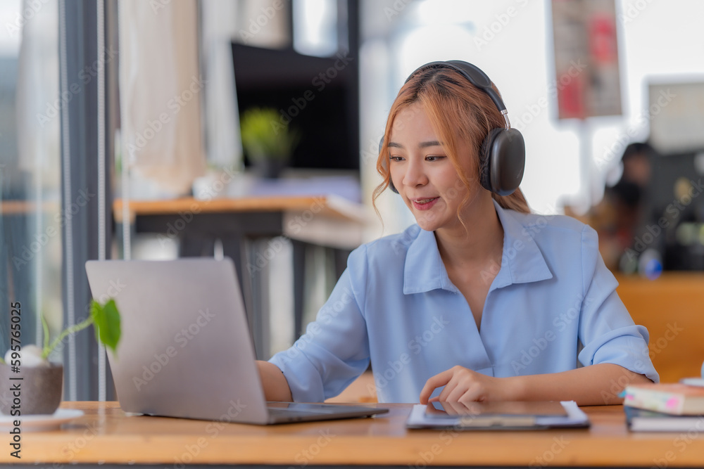 Young student who learns with online platform at coffee shop or co-working space Young student who learns with online platform at coffee shop or co-working space