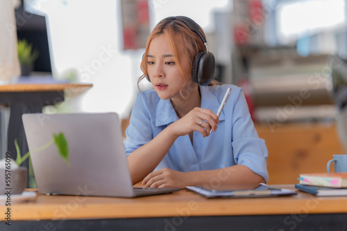 Young student who learns with online platform at coffee shop or co-working space 