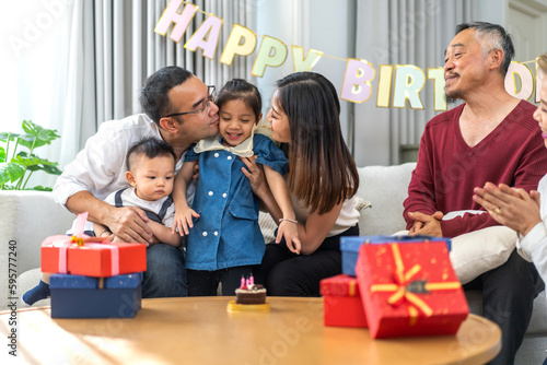 Portrait of happy love asian big family father and mother with asian baby and little girl happy birthday, party, celebration, cake, surprise, grandfather with grandmother smiling together.Family party © Art_Photo