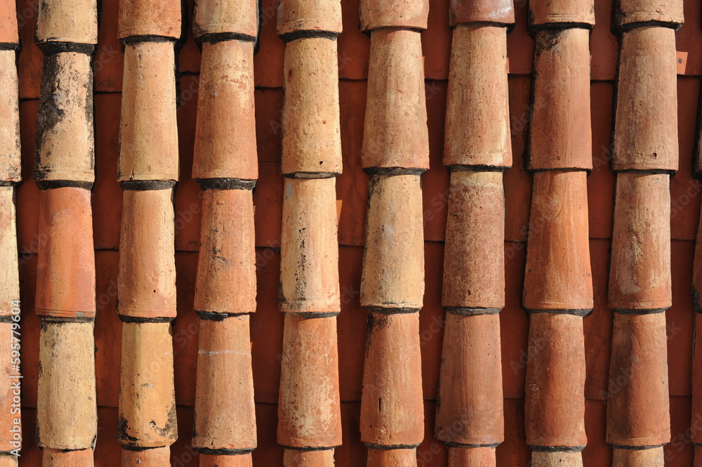 Red and orange roof tiles texture pattern on roof of an old historical building Red and orange roof tiles texture pattern on roof of an old historical building