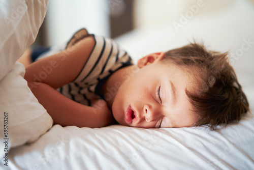 Picture of a tired young boy sleep on holidays