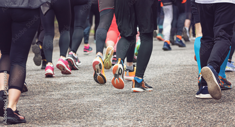 The legs of athletes dressed in special equipment, running a long distance The legs of athletes dressed in special equipment, running a long distance