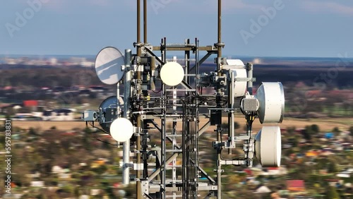 Drone view around the GSM and radio telecommunication tower. Cell phone tower. Wireless communication antenna transmitter.Orbit shot.