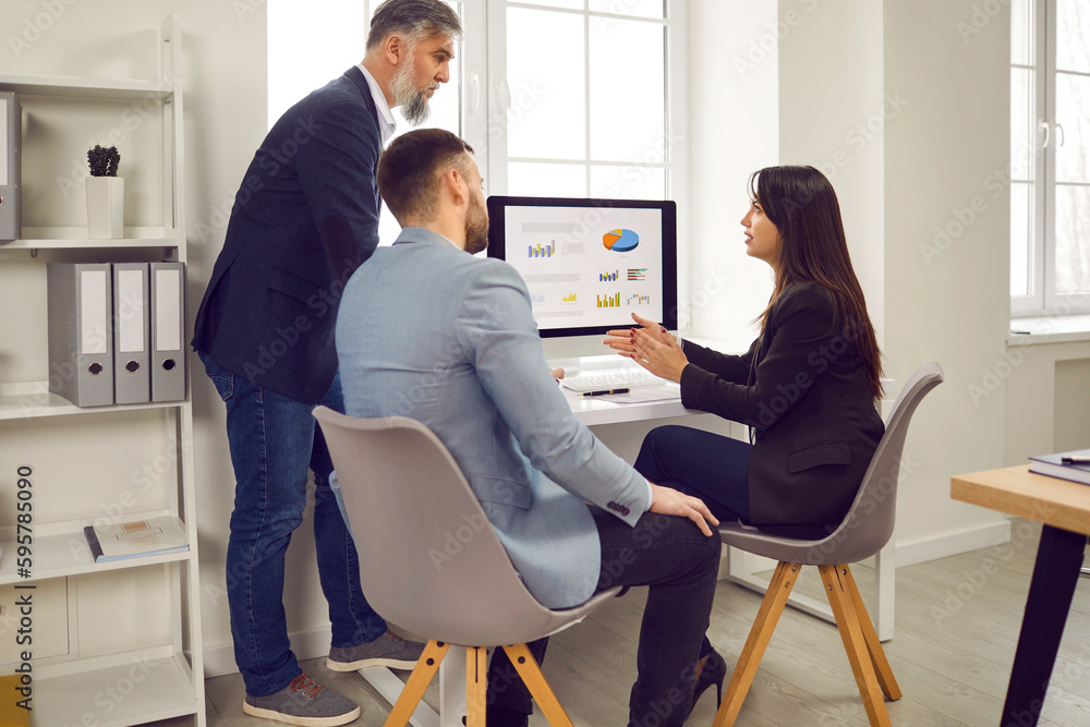 Business people team work group discussing stats financial data on pc computer screen with diagram, charts sitting at the desk in office. Employees or staff analyzing company on meeting. Business people team work group discussing stats financial data on pc computer screen with diagram, charts sitting at the desk in office. Employees or staff analyzing company on meeting.
