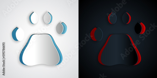 Paper cut Bear paw footprint icon isolated on grey and black background. Paper art style. Vector