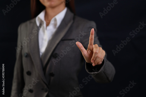 Attractive professional business woman hands standing and pointing something with confident for advertising on black background isolated