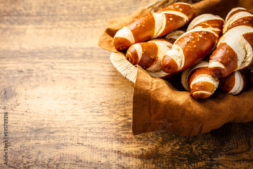 Pretzel sticks and pretzel rolls, Bavarian lye bun with salt in a basket photo