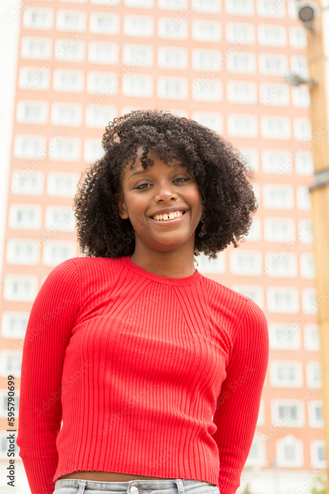 Fototapeta premium Happy Afro woman in city