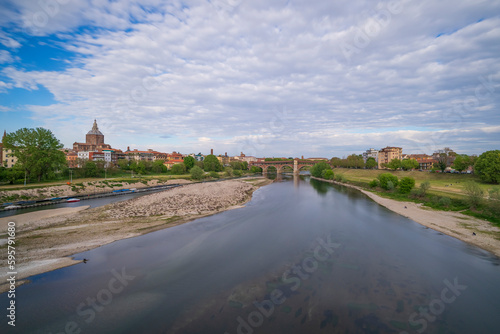 Skyline of Pavia , Ponte Coperto(covered bridge) is a bridge over the Ticino river in Pavia at sunny day, Pavia Cathedral background, Italy