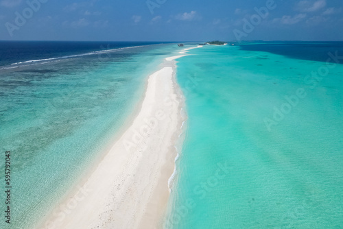 stunning blue ocean and sandy white island maldives top drone aeral view deserted hidden Maldives beach copyspace for text