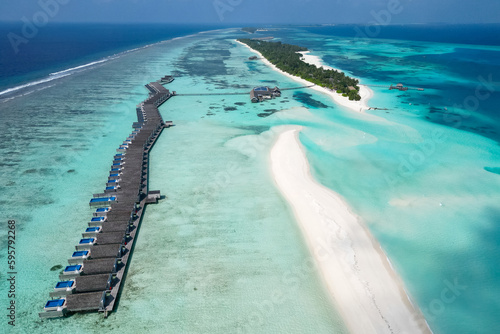 stunning blue ocean and sandy lux hotels on water top drone aeral view Maldives beach copyspace for text