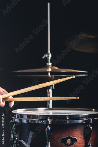 Snare drum and cymbals on a black background.