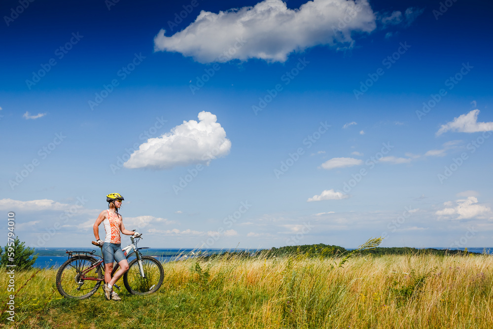Mountain biking - woman with bike enjoy summer vacation Mountain biking - woman with bike enjoy summer vacation