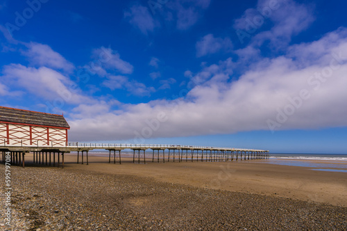 The old Victorian pier stretching out over the beach at low tide. Saltburn-by-the-Sea, Cleveland